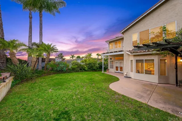 a front view of a house with a garden and yard