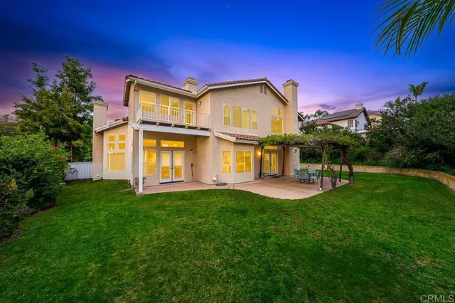 a front view of a house with swimming pool having outdoor seating