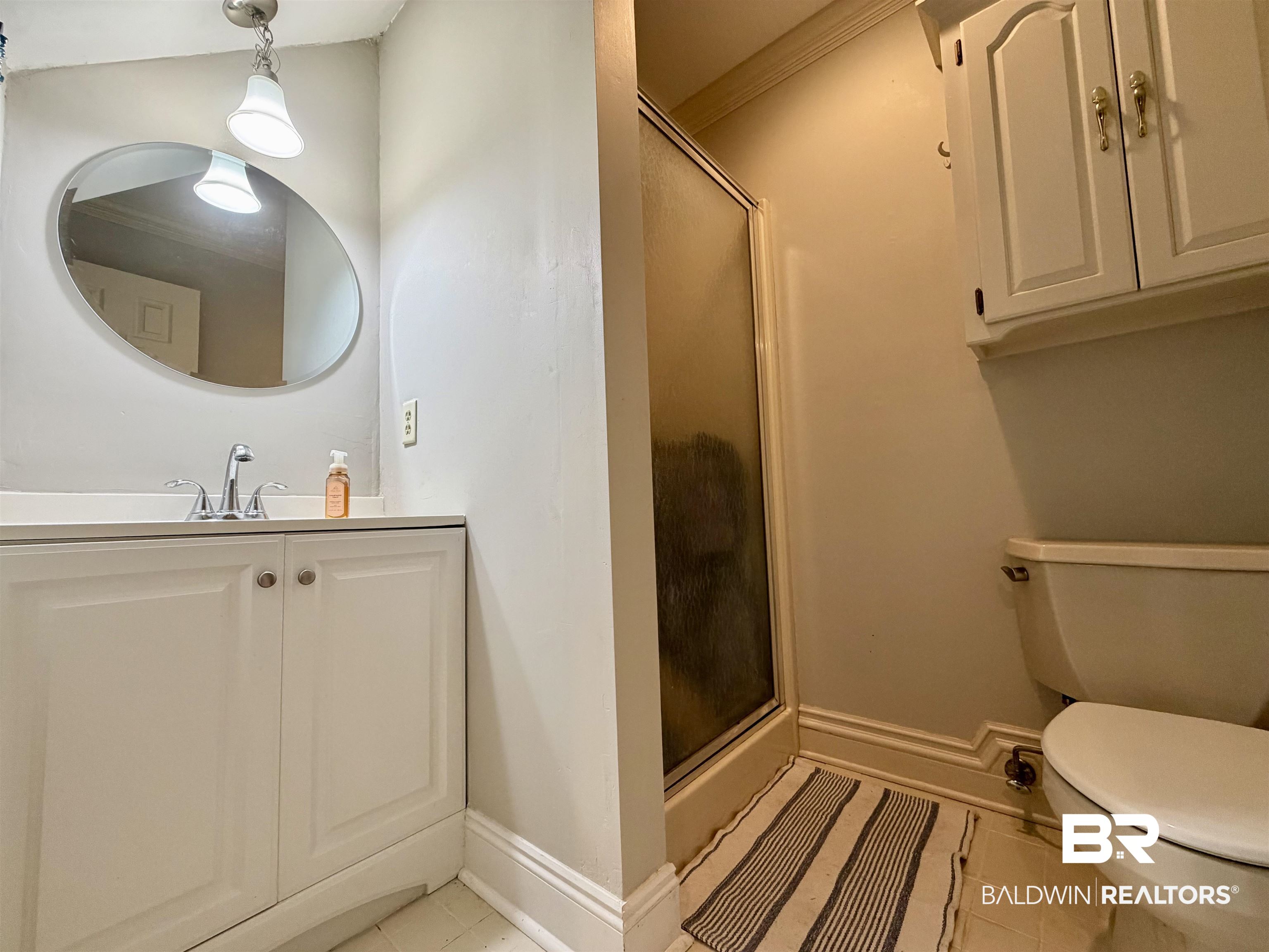 2944 Appleton Road Brewton, AL 36426 - Photo 39 of 65 Bathroom with vanity, a shower stall, crown molding, and light tile patterned flooring