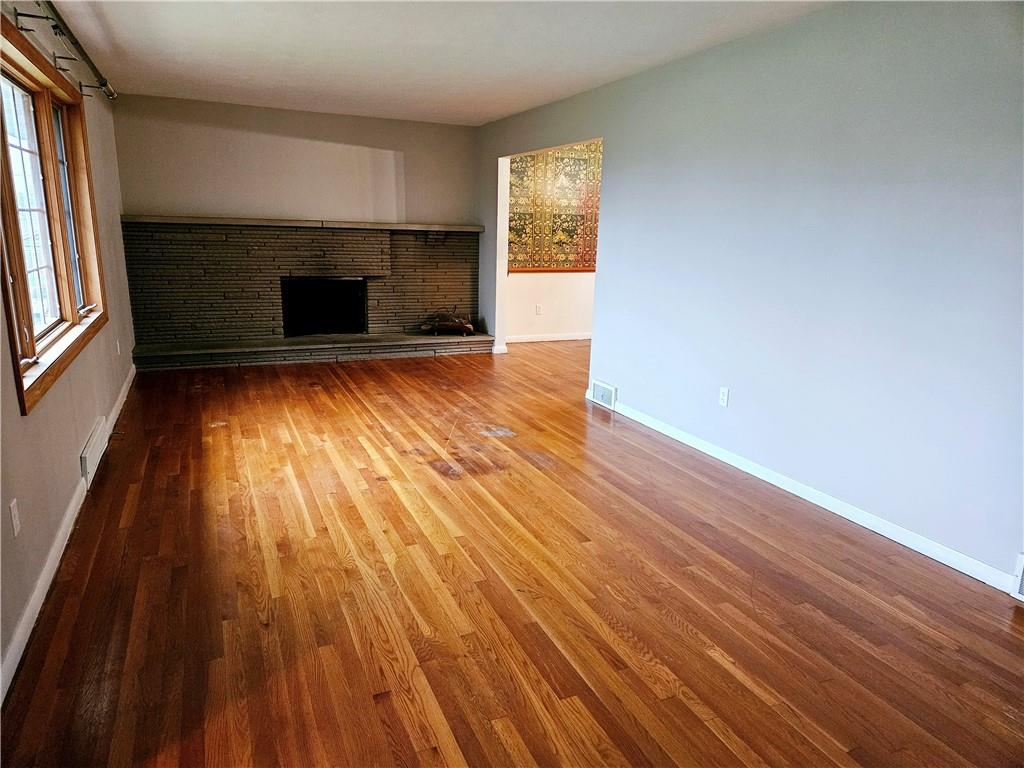 736 Beaver Street Rochester, PA 15074 - Photo 2 of 24 a view of empty room with wooden floor and fireplace