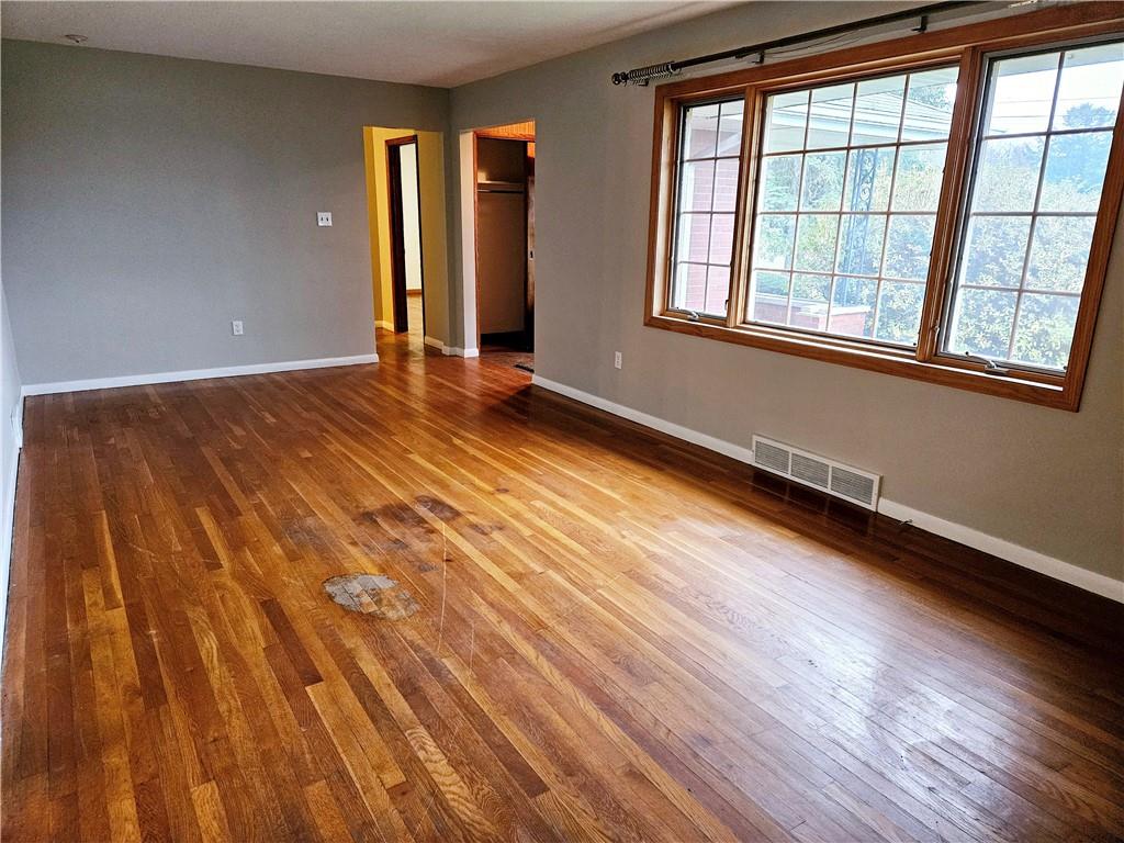 736 Beaver Street Rochester, PA 15074 - Photo 3 of 24 an empty room with wooden floor and windows