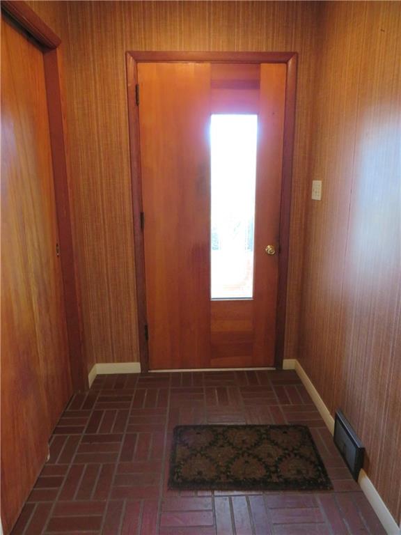 736 Beaver Street Rochester, PA 15074 - Photo 5 of 24 a view of an empty room with wooden floor and a window