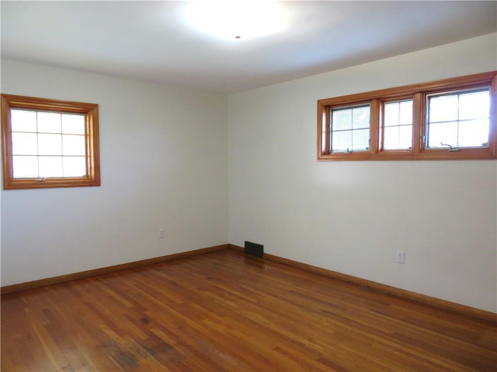 736 Beaver Street Rochester, PA 15074 - Photo 10 of 24 a view of an empty room with wooden floor and a window