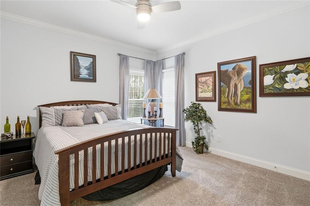 613 Talmadge Lane Canton, GA 30115 - Photo 26 of 84 a bedroom with bed and paintings on the wall