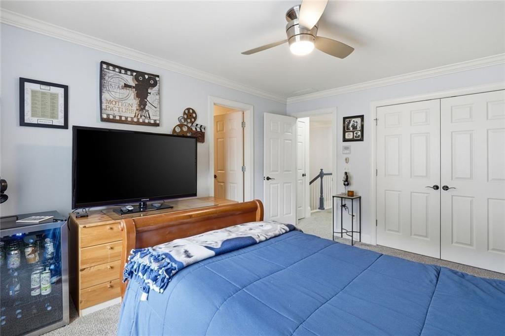 613 Talmadge Lane Canton, GA 30115 - Photo 33 of 84 a bedroom with a bed and a flat screen tv