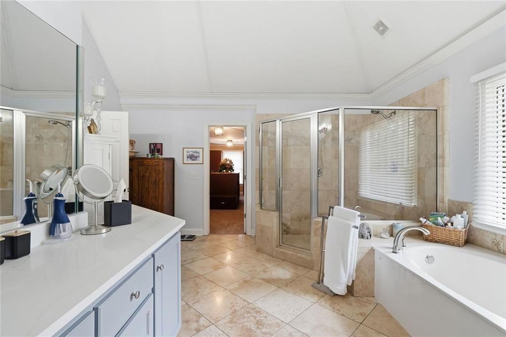 613 Talmadge Lane Canton, GA 30115 - Photo 40 of 84 a large bathroom with a double vanity sink a large mirror and a shower