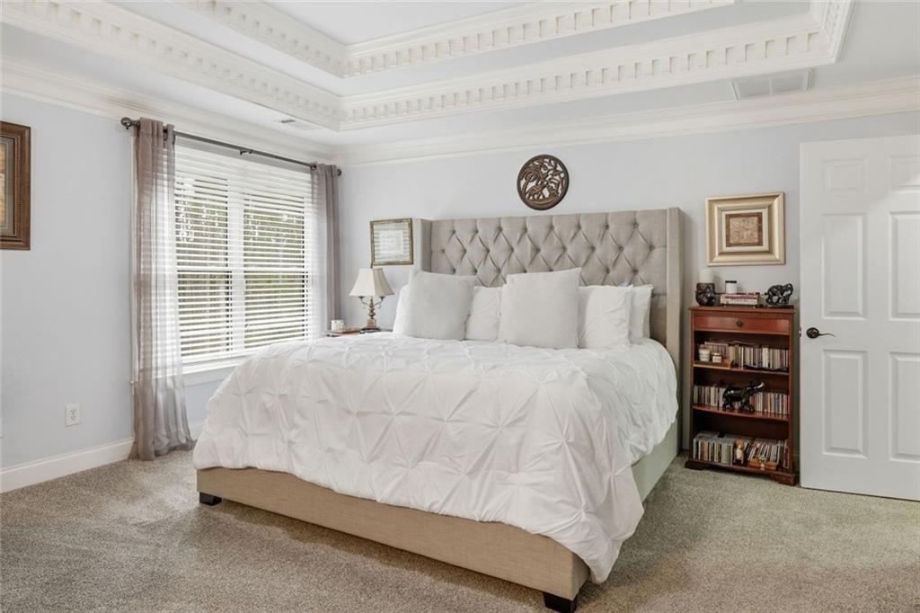 613 Talmadge Lane Canton, GA 30115 - Photo 46 of 84 a bed sitting in a bedroom next to a window and a couch