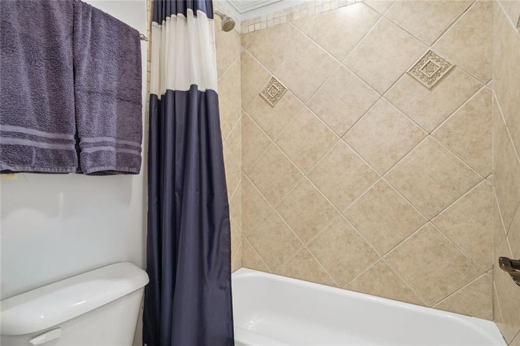 613 Talmadge Lane Canton, GA 30115 - Photo 50 of 84 a bathroom with a shower and a toilet