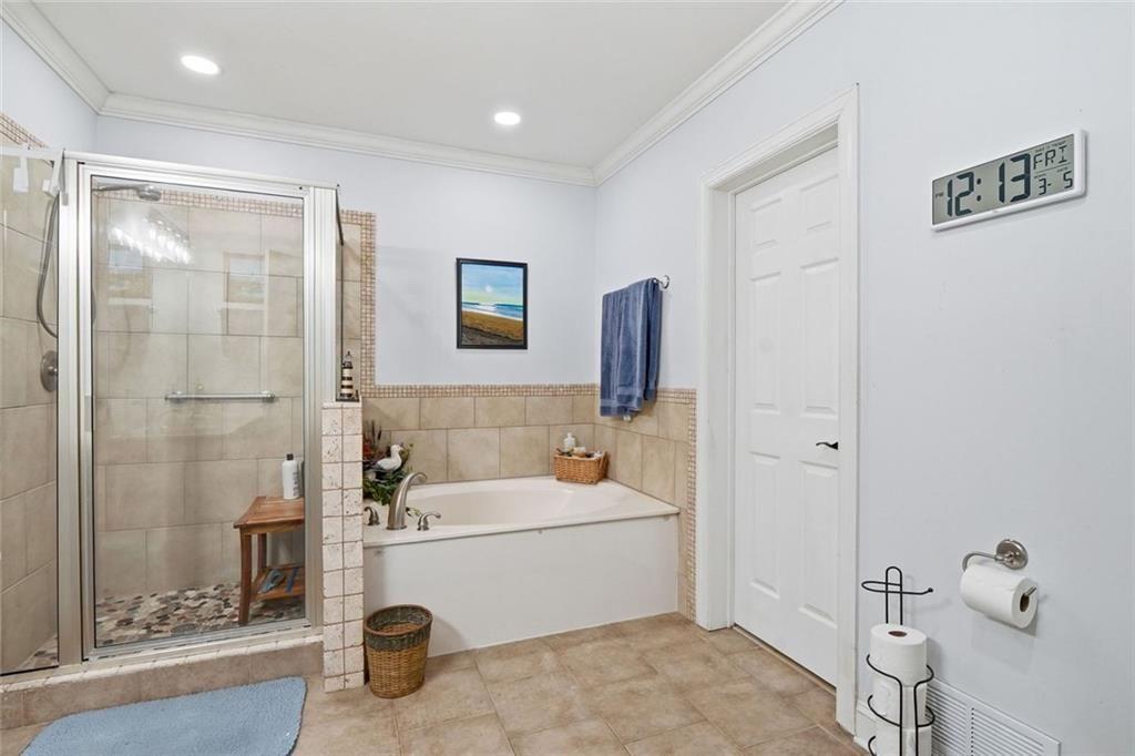 613 Talmadge Lane Canton, GA 30115 - Photo 54 of 84 a bathroom with a tub a sink and a mirror