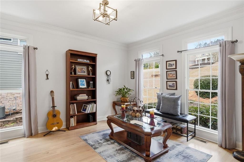 613 Talmadge Lane Canton, GA 30115 - Photo 10 of 84 a living room with furniture a bookshelf and a window