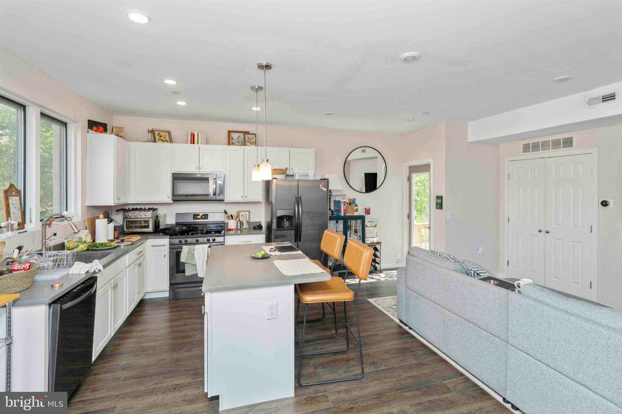 1309 South 20th Street Philadelphia, PA 19146 - Photo 14 of 37 a kitchen with stainless steel appliances a stove a sink cabinets and wooden floor