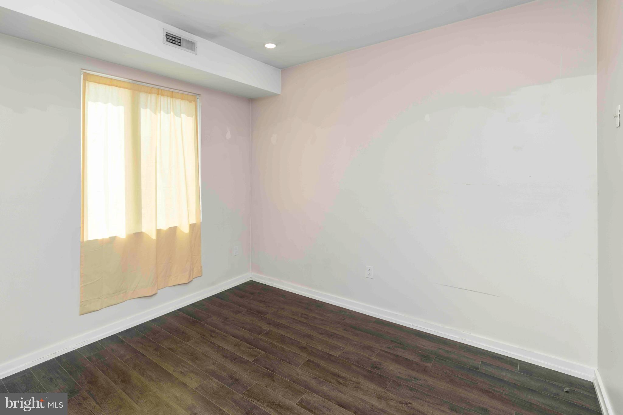 1309 South 20th Street Philadelphia, PA 19146 - Photo 33 of 37 an empty room with wooden floor and windows