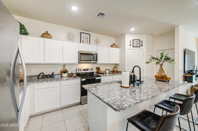a kitchen with sink cabinets and stove top oven