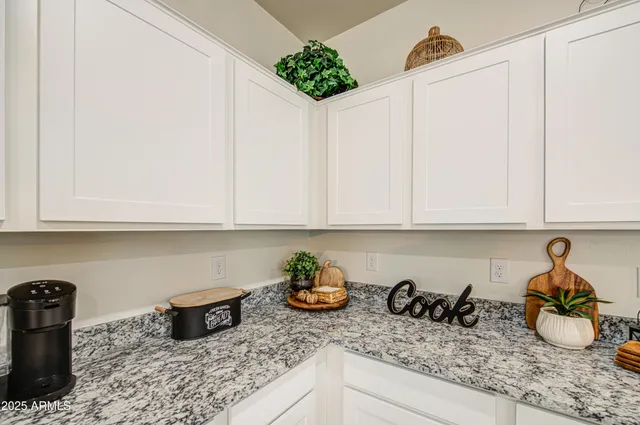 a kitchen with a refrigerator and cabinets