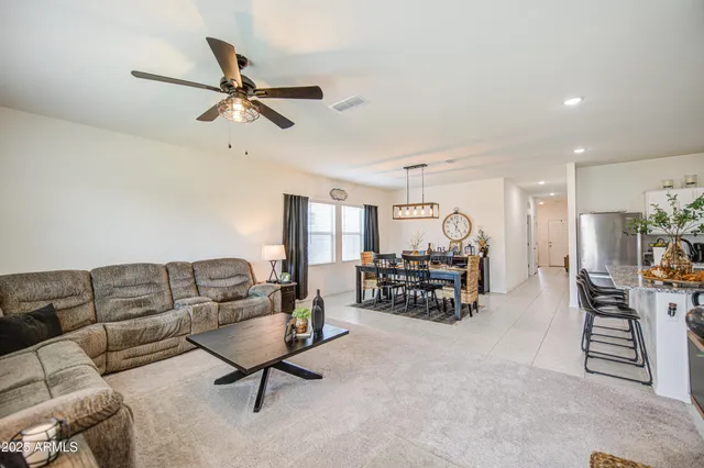a living room with furniture and kitchen view