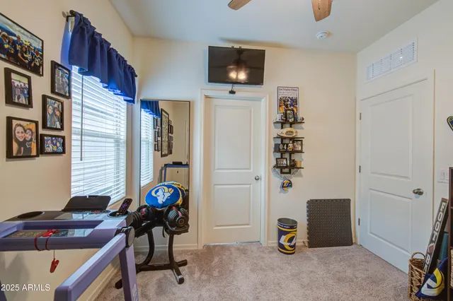 a view of a workspace with furniture and a window