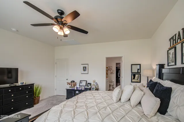 a bedroom with a bed and a tv