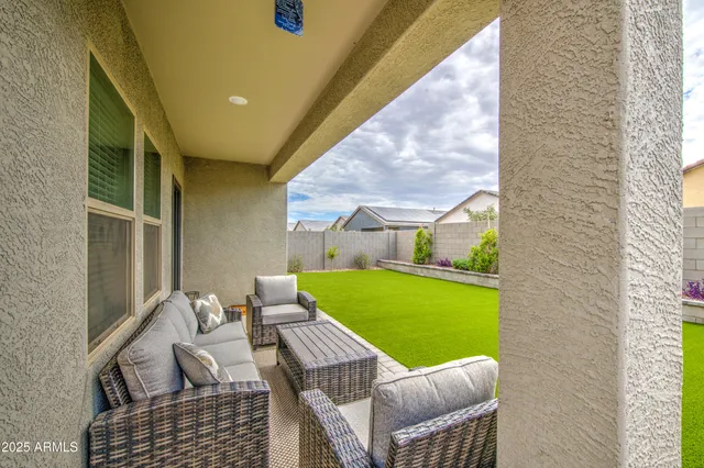 a balcony with chairs and a table