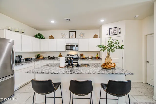 a kitchen with stainless steel appliances granite countertop a counter top space cabinets and wooden floor