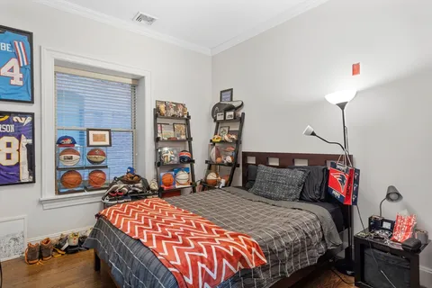 a bedroom with a bed and dresser
