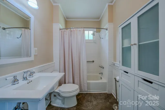 a bedroom with a bed and large window