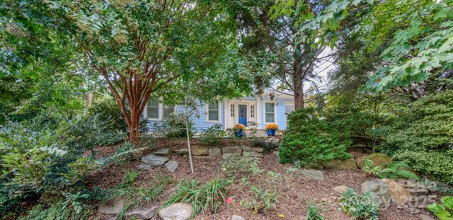 a backyard of a house with lots of green space and fountain view