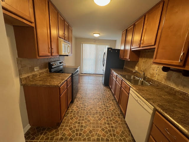711 South River Road, Unit 511 Des Plaines, IL 60016 - Photo 11 of 23 a kitchen with sink cabinets and refrigerator