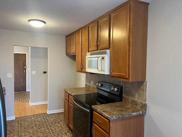 711 South River Road, Unit 511 Des Plaines, IL 60016 - Photo 13 of 23 a kitchen with granite countertop stainless steel appliances a stove top oven