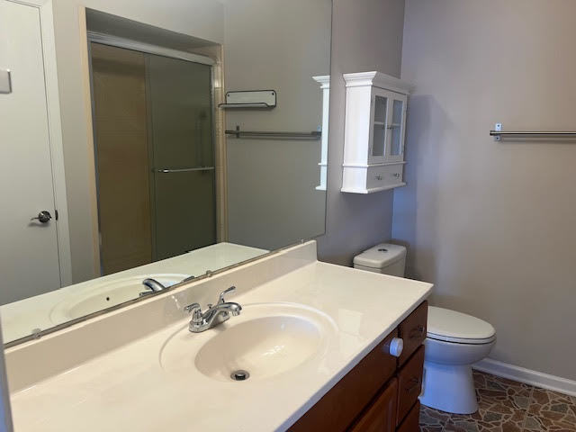 711 South River Road, Unit 511 Des Plaines, IL 60016 - Photo 17 of 23 a bathroom with a sink toilet and vanity
