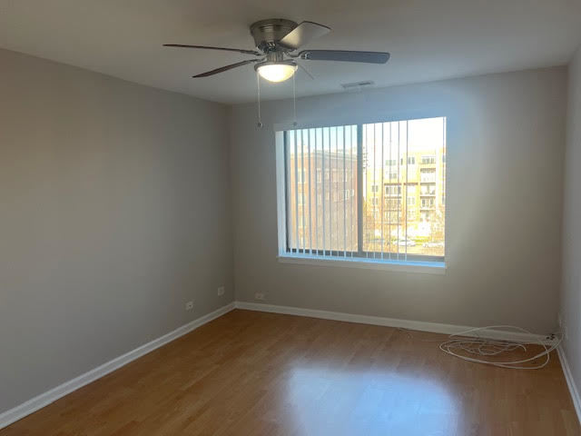 711 South River Road, Unit 511 Des Plaines, IL 60016 - Photo 20 of 23 an empty room with a window and a fan