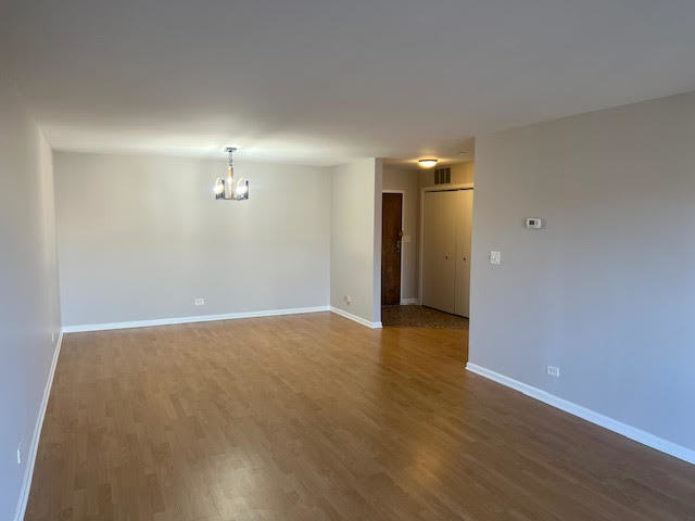 711 South River Road, Unit 511 Des Plaines, IL 60016 - Photo 3 of 23 a view of an empty room with wooden floor