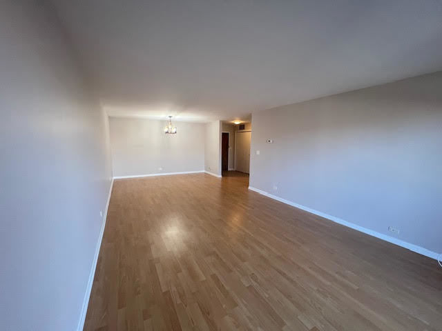 711 South River Road, Unit 511 Des Plaines, IL 60016 - Photo 6 of 23 a view of a room with wooden floor and window