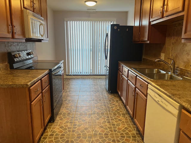 711 South River Road, Unit 511 Des Plaines, IL 60016 - Photo 8 of 23 a kitchen with granite countertop a refrigerator and a stove