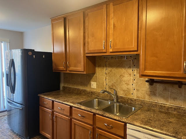 711 South River Road, Unit 511 Des Plaines, IL 60016 - Photo 9 of 23 a kitchen with a refrigerator and cabinets