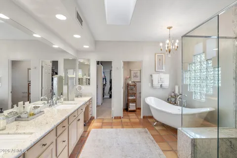 a spacious bathroom with a bathtub and shower