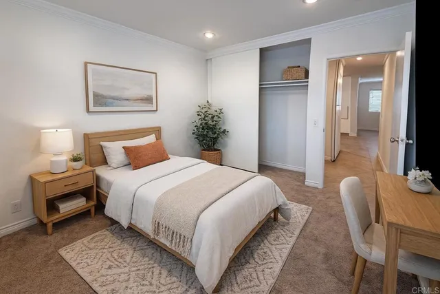 a bedroom with bed and wooden floor