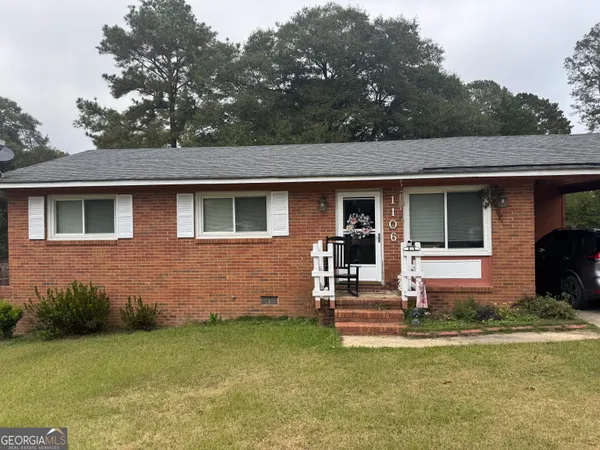 a front view of a house with a garden