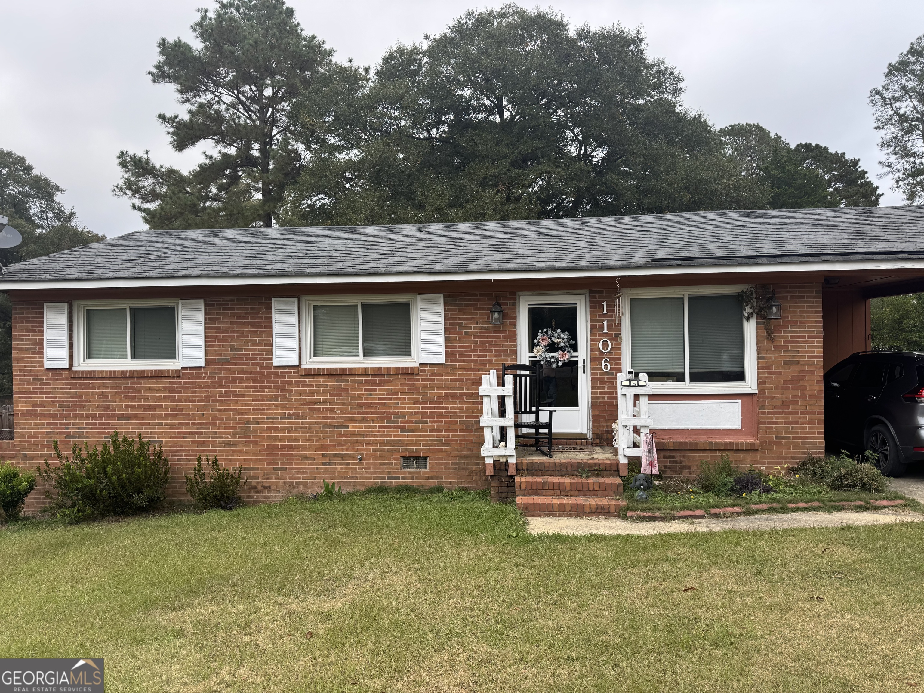 a front view of a house with a garden