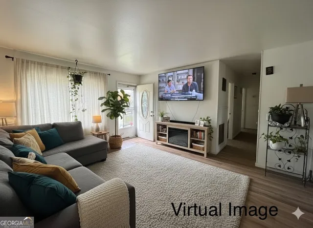 a living room with furniture and a flat screen tv