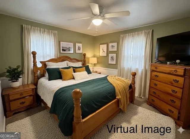a bedroom with a bed and a flat tv screen on dresser