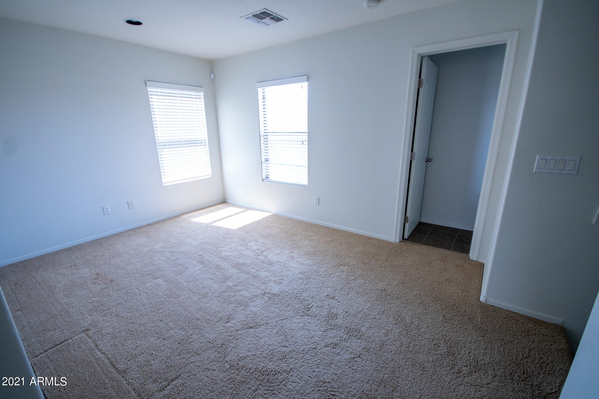 6433 West Harwell Road Laveen, AZ 85339 - Photo 12 of 18 an empty room with windows