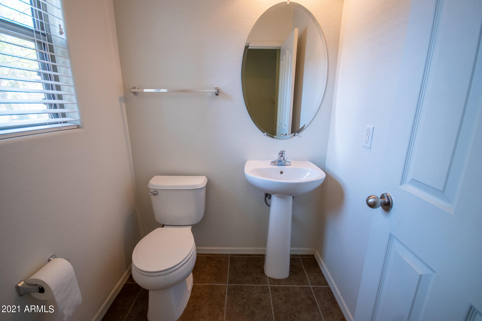 6433 West Harwell Road Laveen, AZ 85339 - Photo 17 of 18 a bathroom with a sink toilet and a mirror