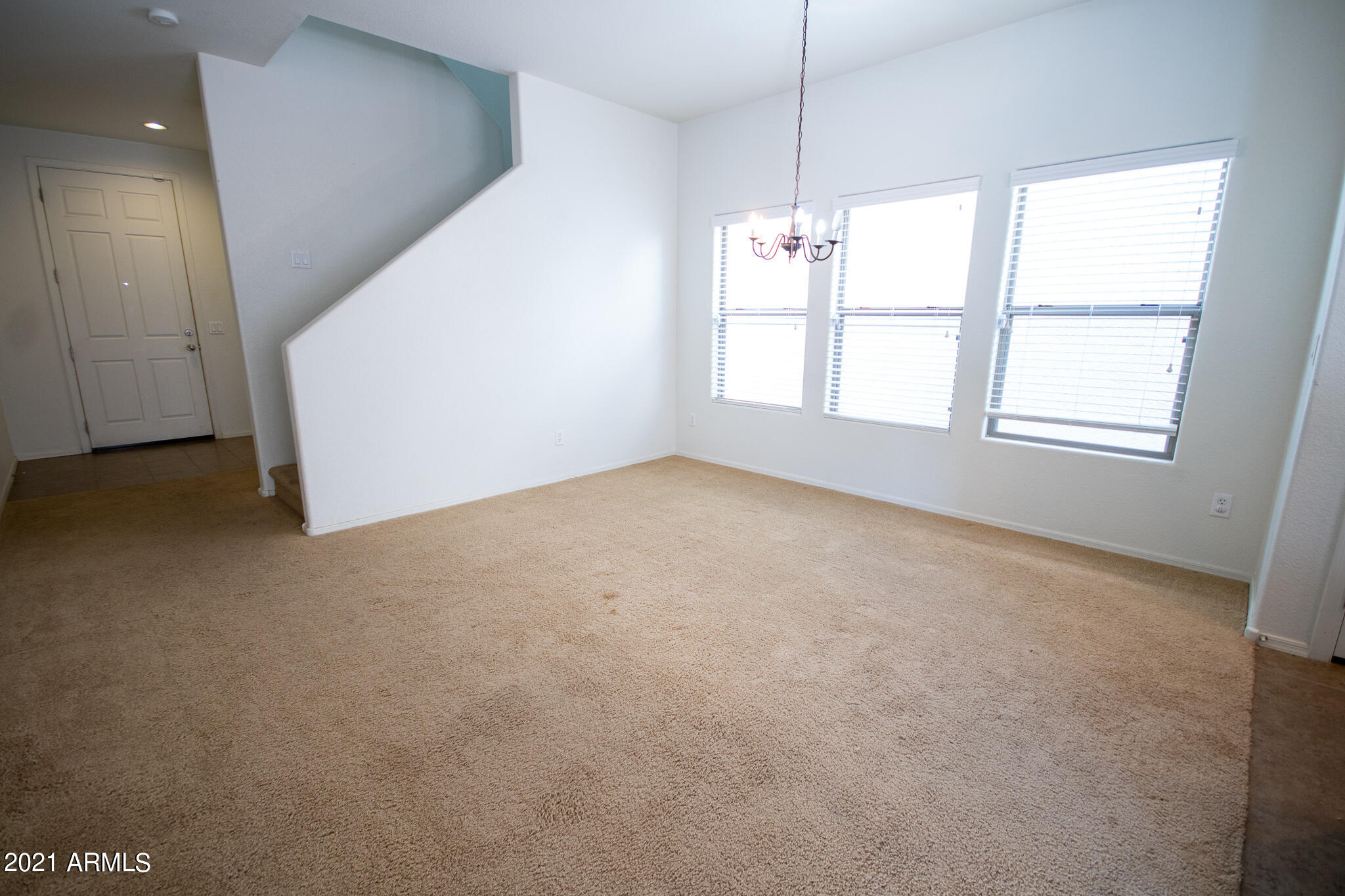6433 West Harwell Road Laveen, AZ 85339 - Photo 2 of 18 an empty room with windows and ceiling fan