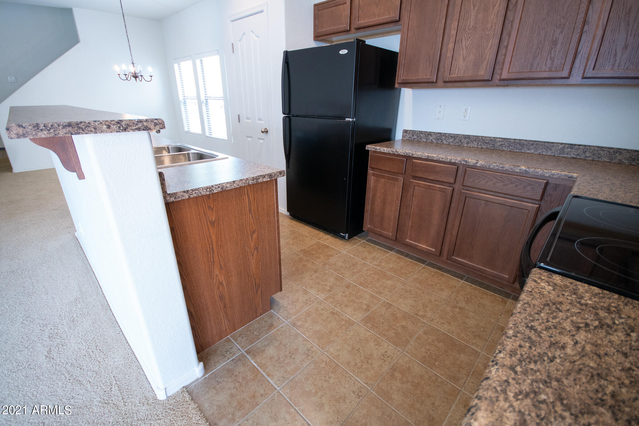 6433 West Harwell Road Laveen, AZ 85339 - Photo 4 of 18 a kitchen with stainless steel appliances a refrigerator and a stove
