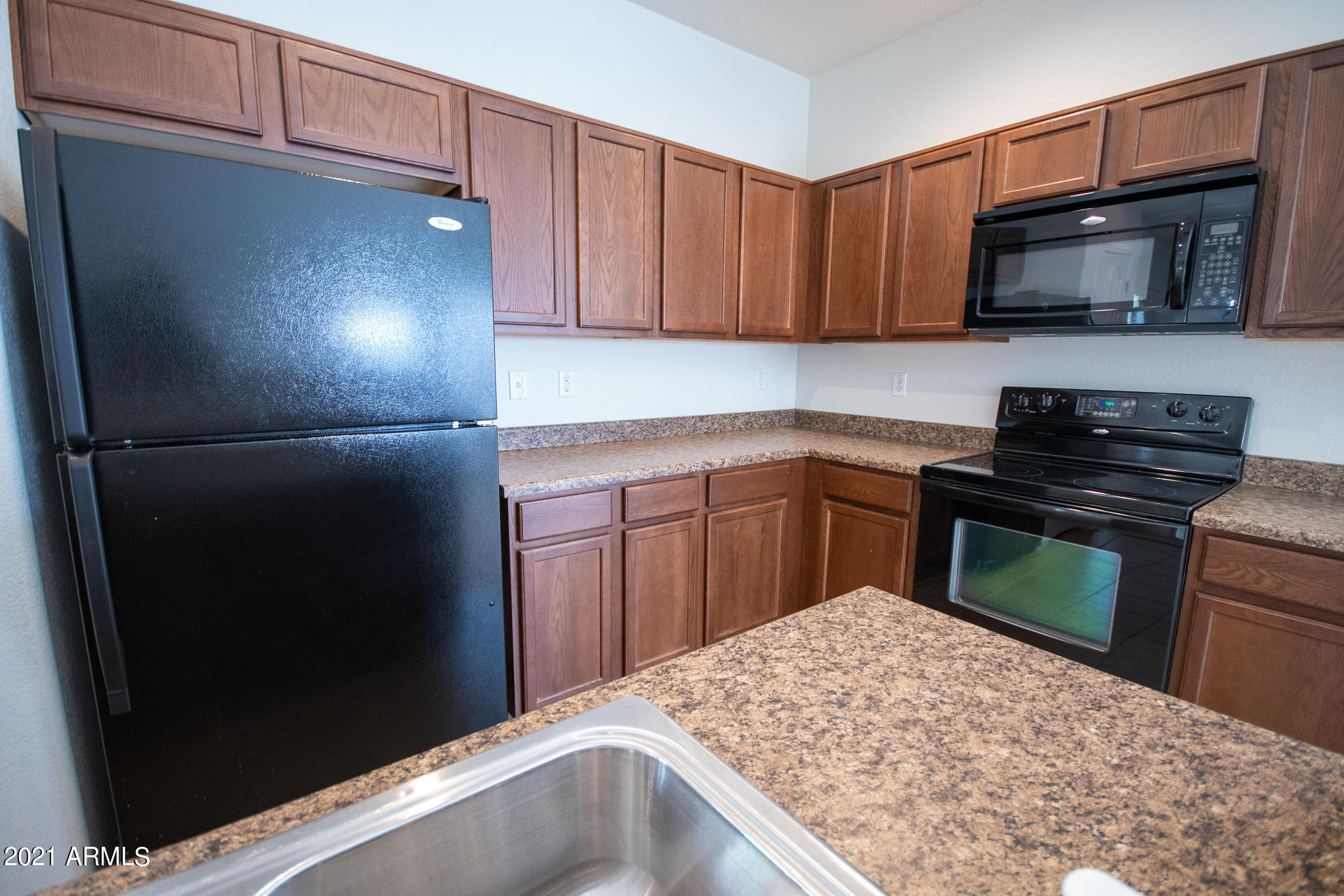 6433 West Harwell Road Laveen, AZ 85339 - Photo 5 of 18 a kitchen with a refrigerator and a sink