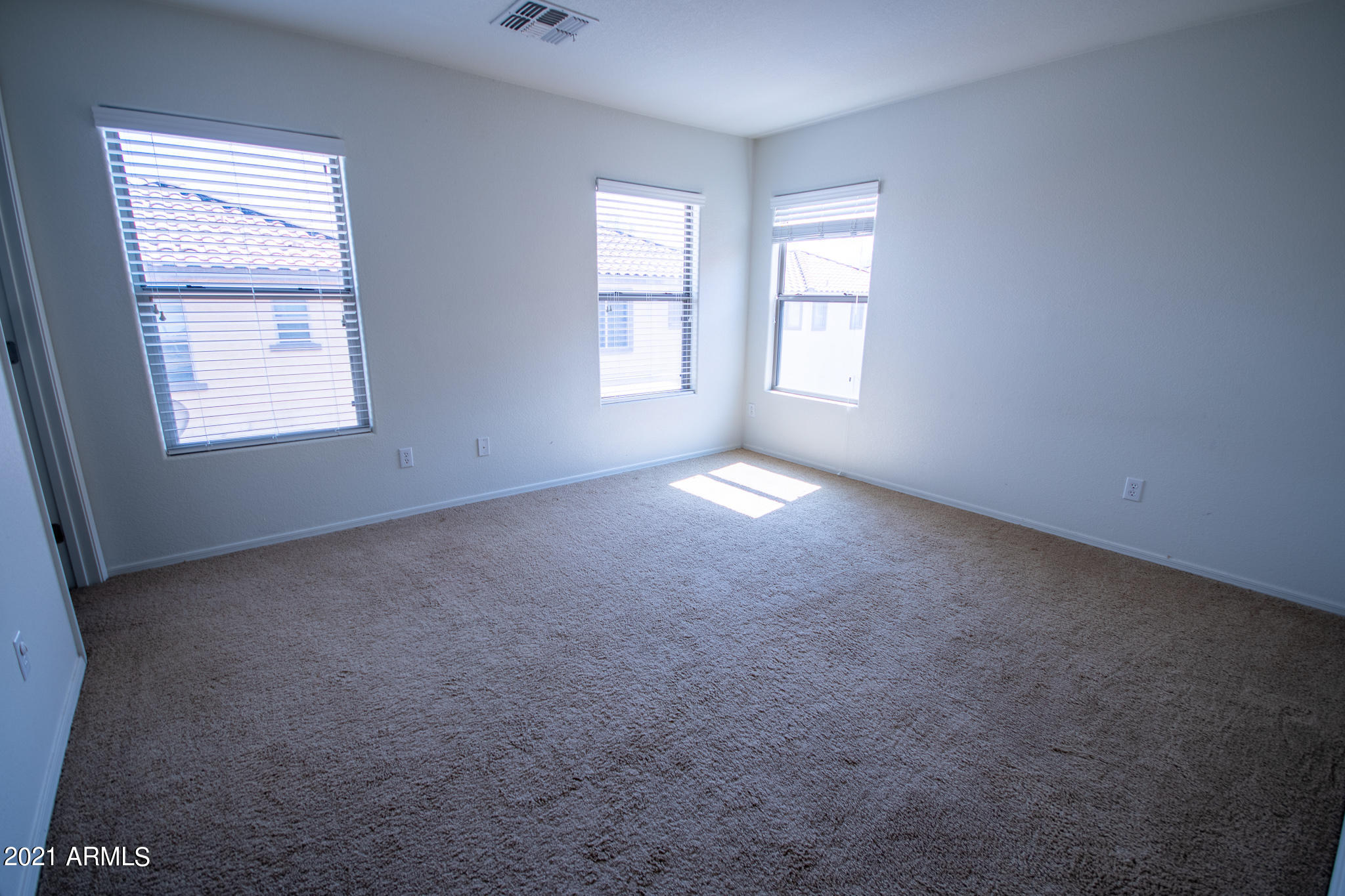 6433 West Harwell Road Laveen, AZ 85339 - Photo 9 of 18 an empty room with windows