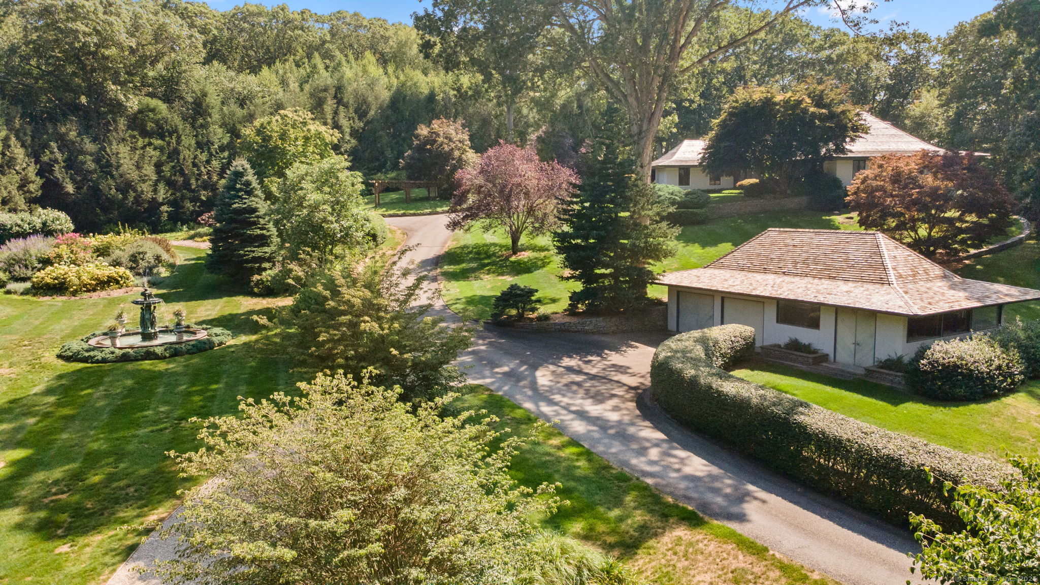 a view of a house with a yard and sitting area