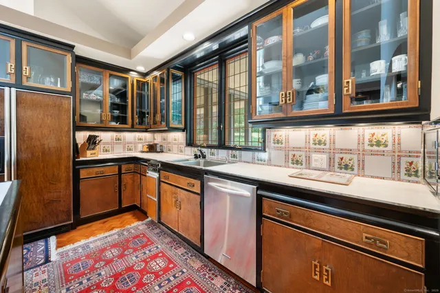 a kitchen with stainless steel appliances a sink and cabinets