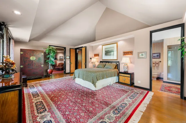 a bedroom with furniture and a rug