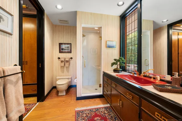 a bathroom with a double vanity sink toilet and shower